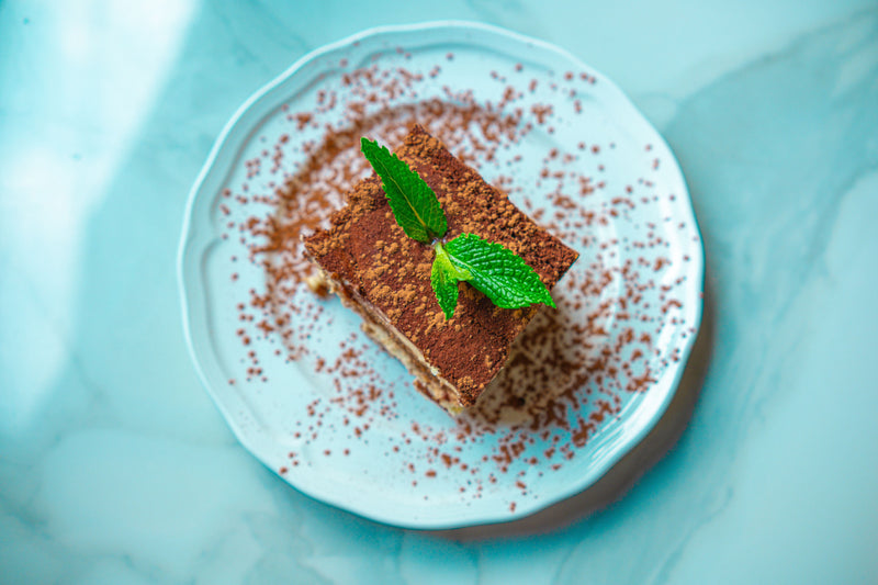 A beautifully crafted authentic tiramisu dusted with cocoa powder, made with Crema Peaks specialty coffee for a richer, cleaner flavor."