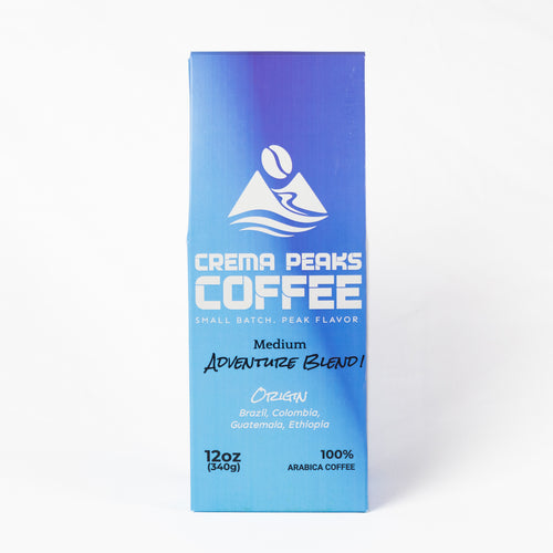 A tall rectangular coffee bag package for Crema Peaks Coffee, featuring a blue-to-light-blue gradient design with white text and logo, photographed against a clean white background.