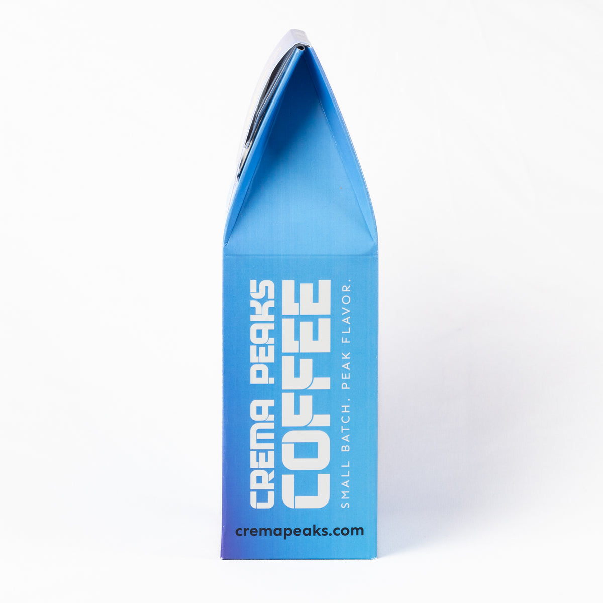 A blue and purple gradient coffee box for Crema Peaks Coffee, featuring white text and a black top flap, photographed on a clean white background.