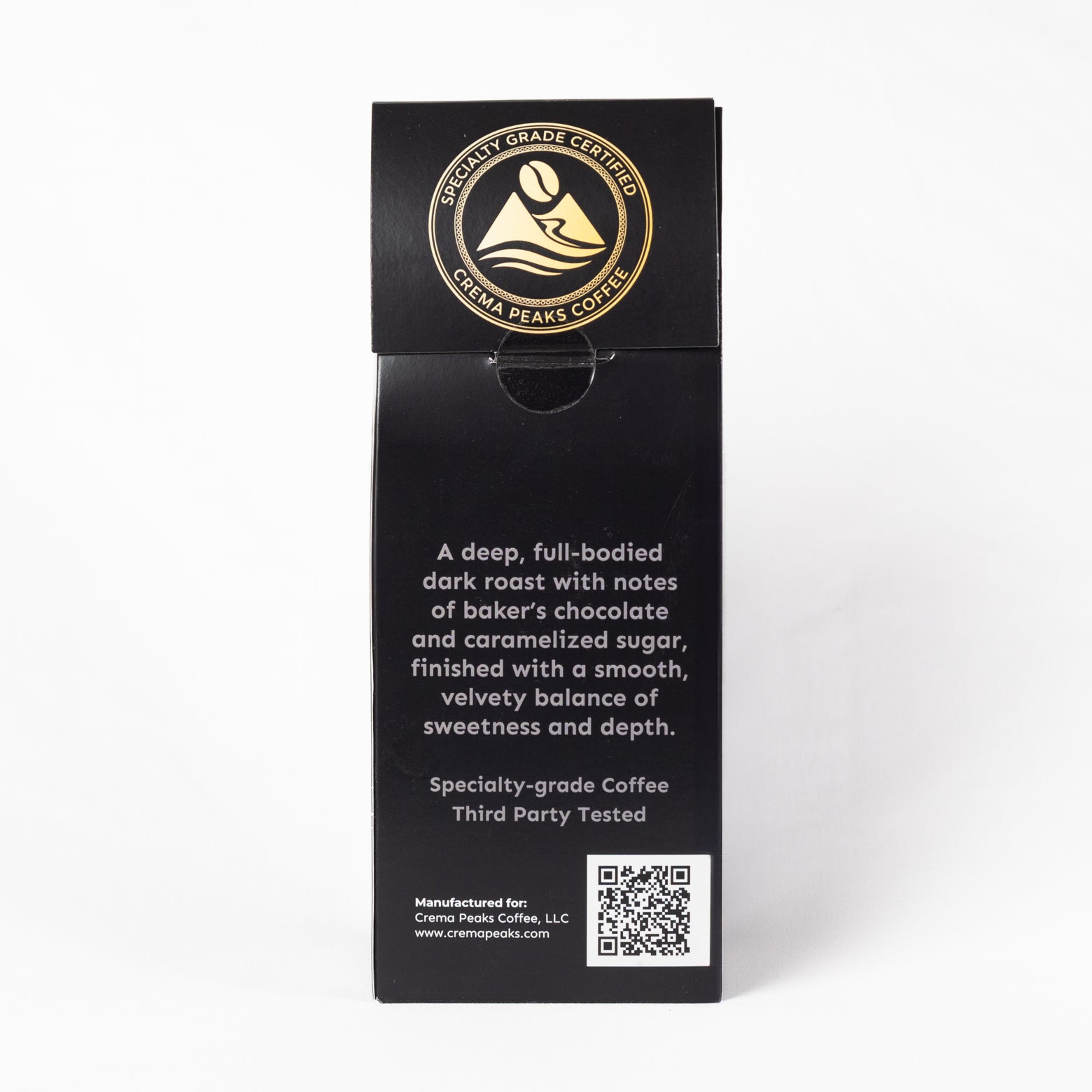 A tall black coffee bag package standing upright on a white background. The front has a circular gold logo reading 'Specialty-Grade Espresso' and 'Creme Peak Coffee,' with descriptive text below in white and a QR code near the bottom.