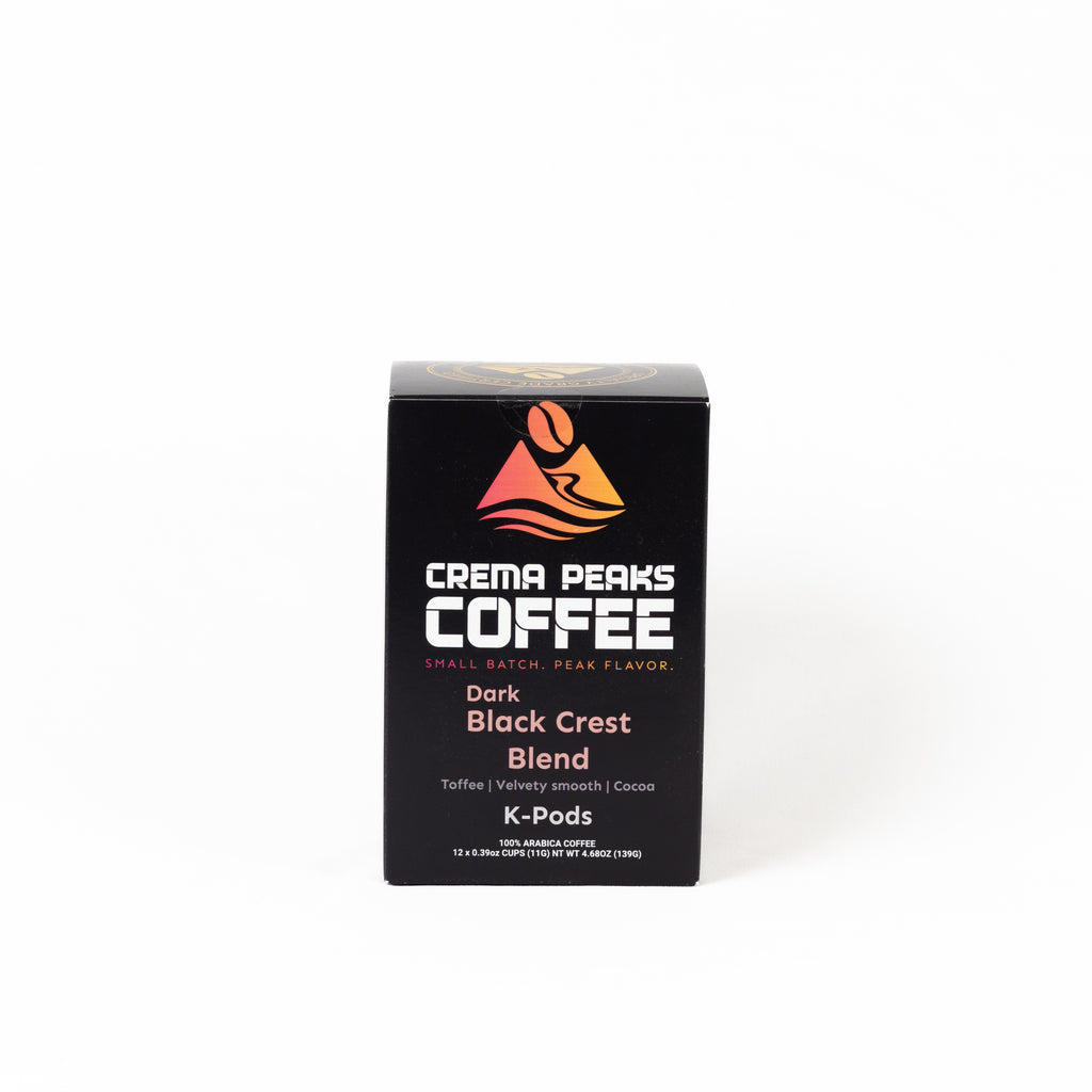 A black box of Crema Peaks Coffee Dark Black Crest Blend K-Pods on a clean white background.