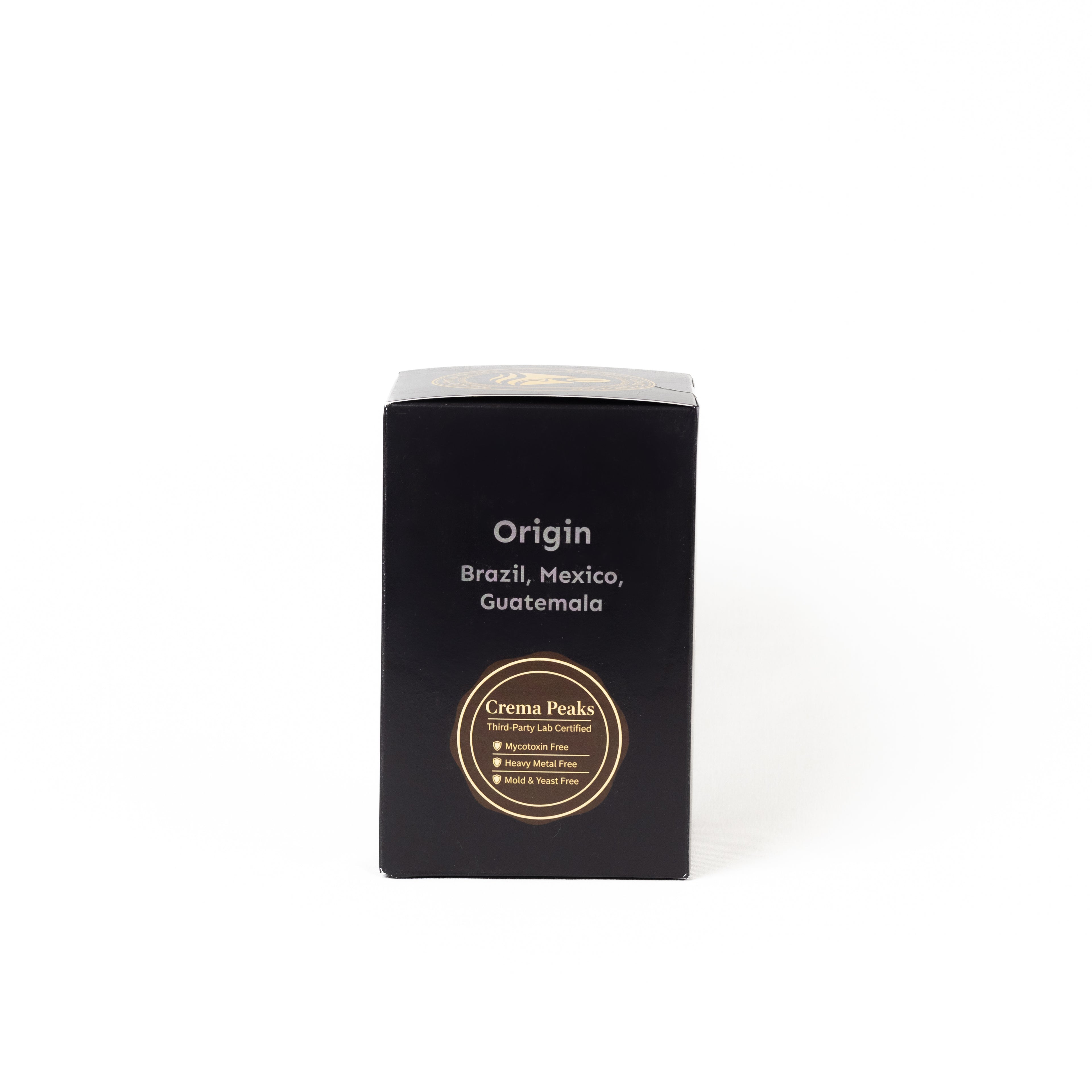 A black rectangular product box with white text reading 'Origin' and 'Brazil, Mexico, Guatemala' plus a circular gold label near the bottom, photographed on a clean white background.