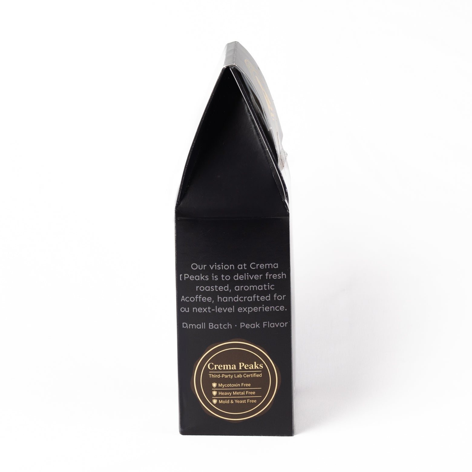 A tall, black coffee bag packaging box with white text and a gold circular logo at the bottom, photographed on a clean white background.