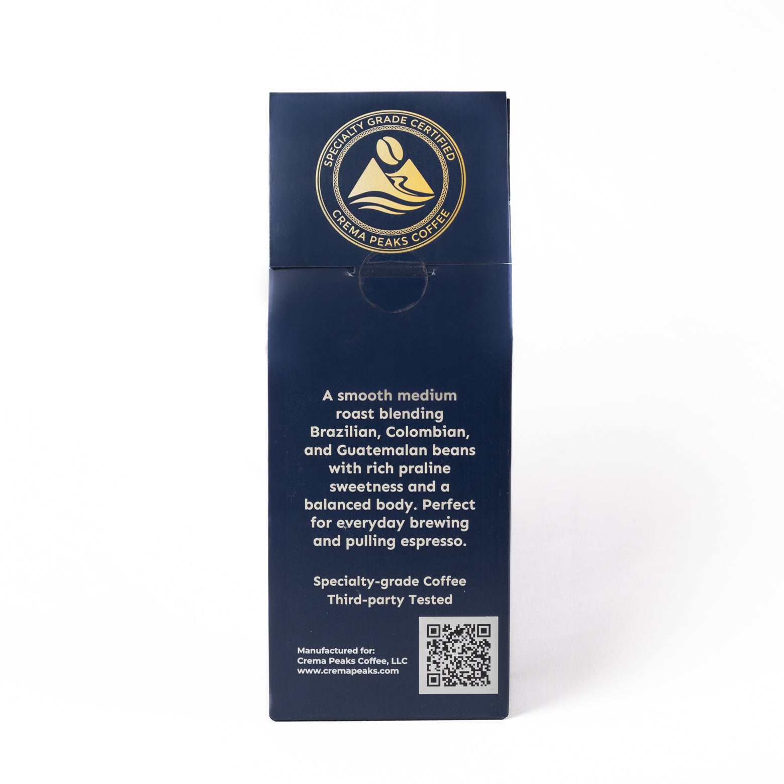 A tall, dark blue coffee bag package shown upright on a white background. The front features a circular gold and white logo for 'Specialty-grade Coffee' and white text describing a smooth medium roast coffee blend from Brazil, Colombia, and Guatemala.