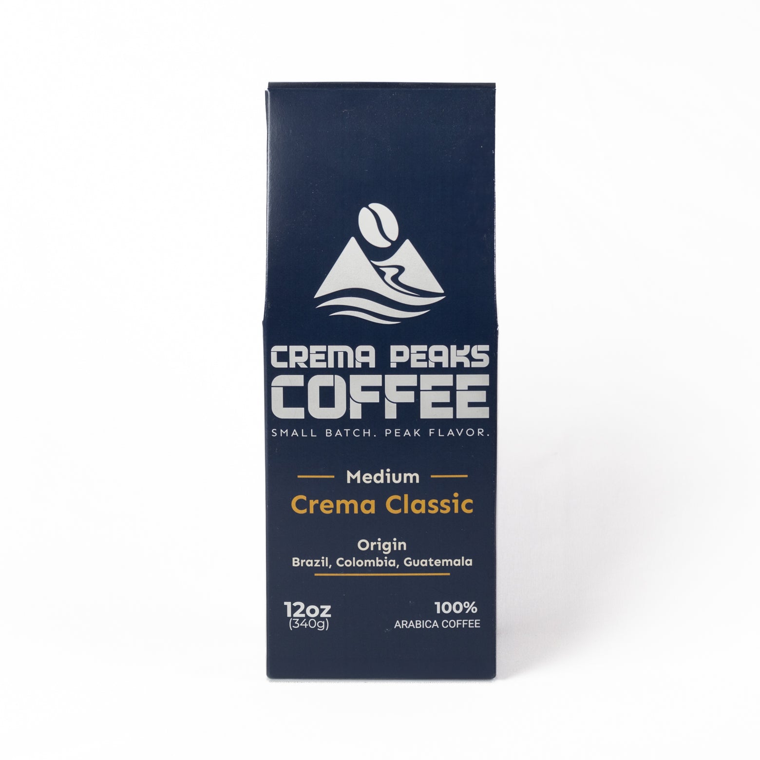 A tall, dark navy coffee box from Crema Peaks Coffee, featuring white and orange text for 'Medium Crema Classic' on a clean white background.