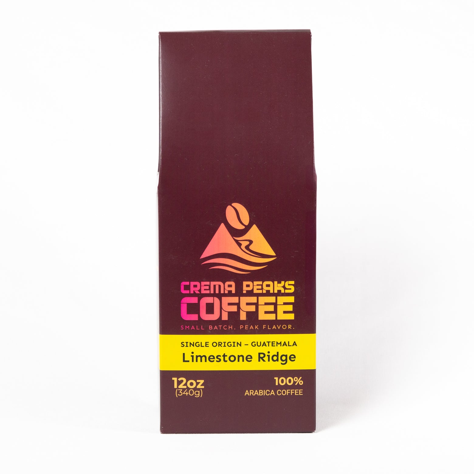 A 12 oz package of Crema Peaks Coffee, Limestone Ridge single origin Guatemala arabica coffee. The packaging is a tall, dark maroon-brown box with a yellow band and a colorful mountain logo, set against a plain white background.
