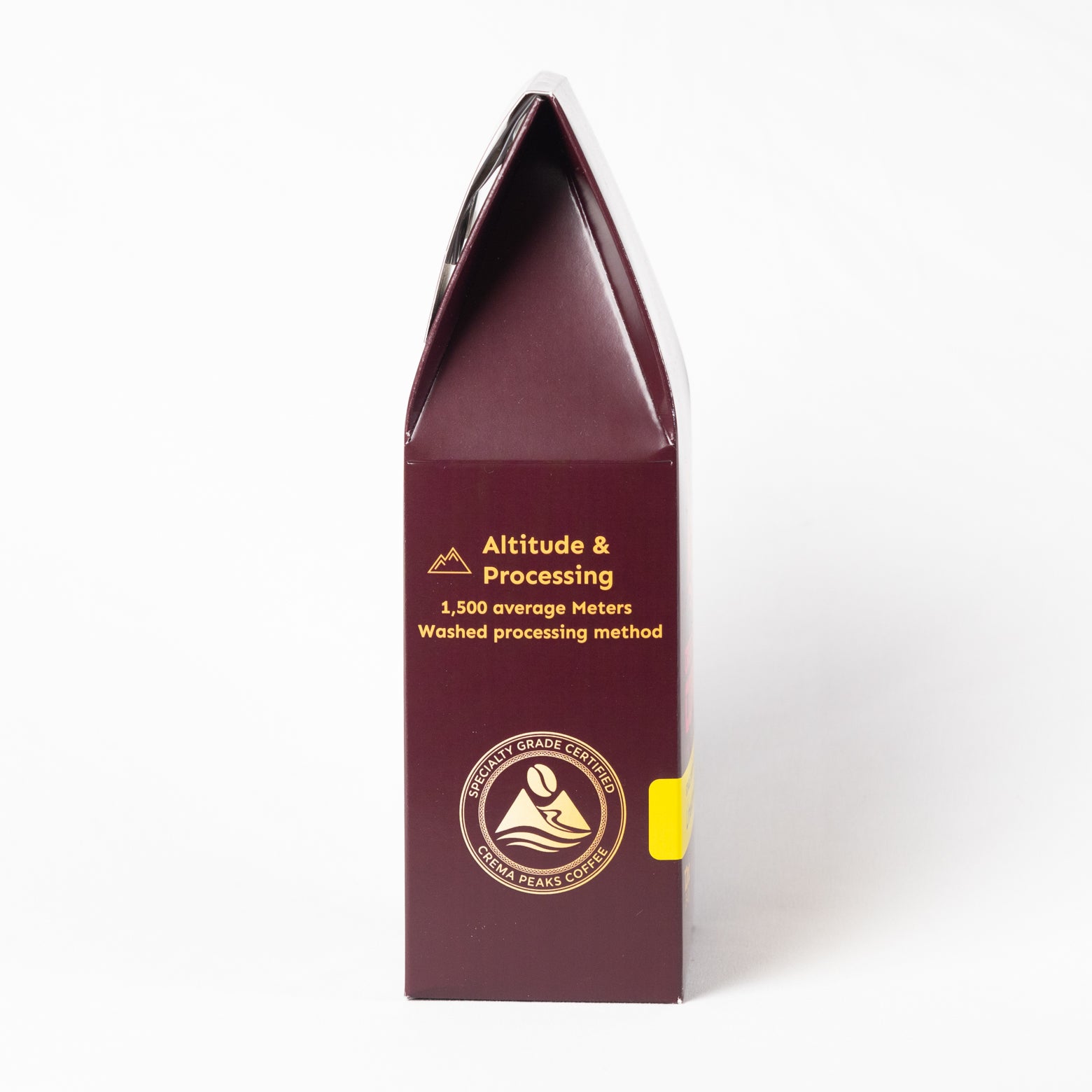 A tall, dark burgundy coffee bag packaging sleeve with gold text reading 'Altitude & Processing' and a small yellow accent tab on the right side, photographed against a clean white background.