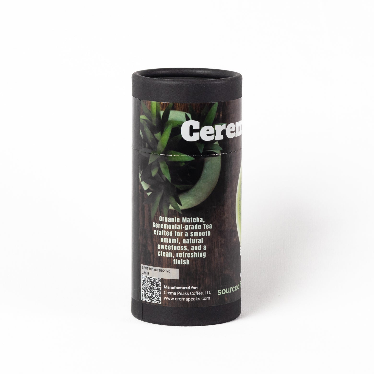 A black cardboard cylindrical tube of Organic Ceremonial Grade Matcha Tea from Source Coffee Roasters, featuring a label with green tea leaves and white text on a clean white background.