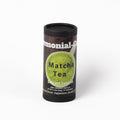 A cylindrical black container of organic ceremonial matcha tea with a dark label featuring a green matcha cup graphic and white text, photographed on a clean white background.