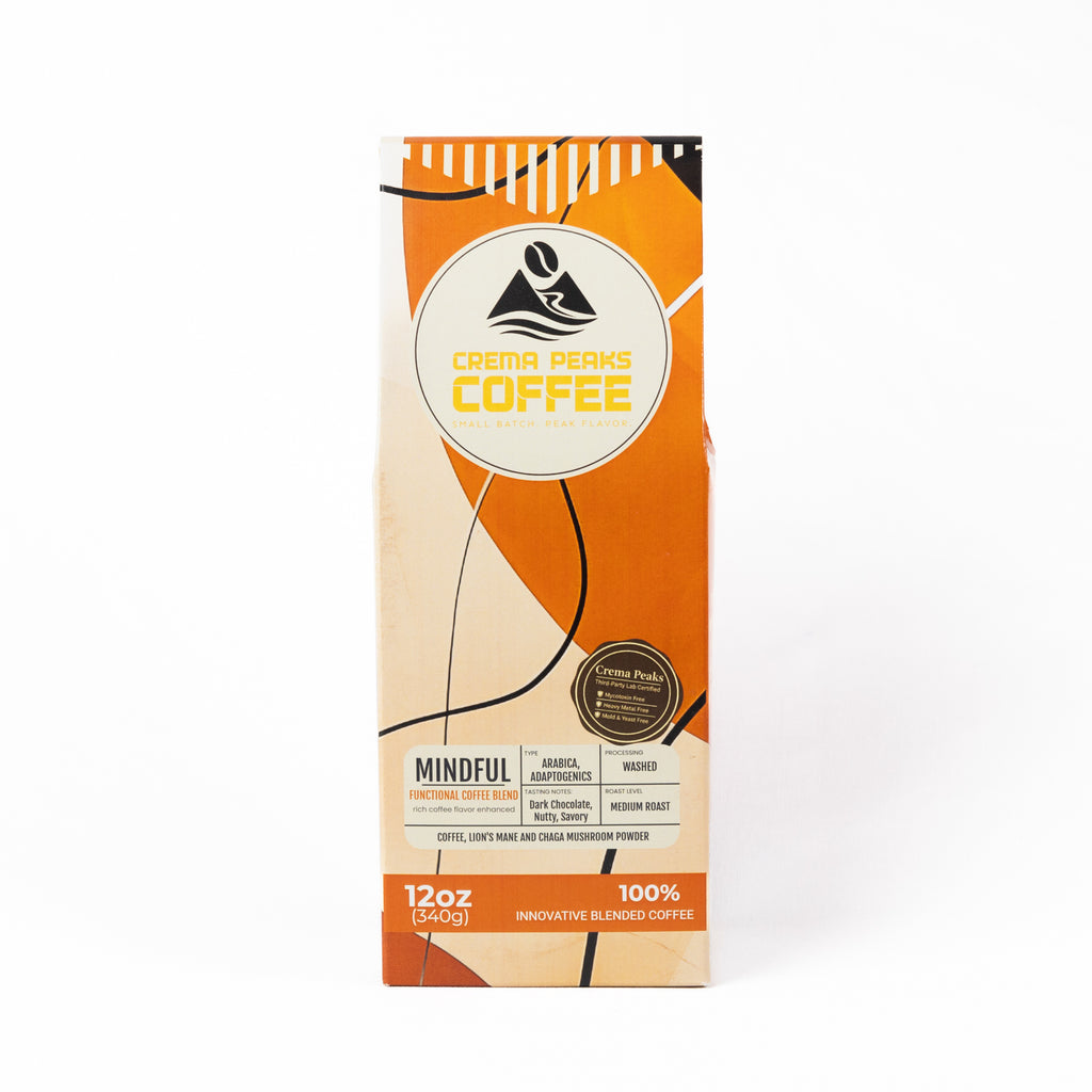 A 12oz bag of Crema Peaks Coffee 'Mindful' innovative blended coffee, featuring an orange and beige geometric design with black accents on a white background.
