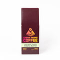 A tall rectangular coffee bag package for Crema Peaks Coffee, Sidama Sunrise, shown upright on a clean white background. The package is dark burgundy with a cream band and orange/yellow logo and text.