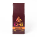 A tall, narrow package of Crema Peaks Coffee Summit Crest single-origin coffee on a plain white background.