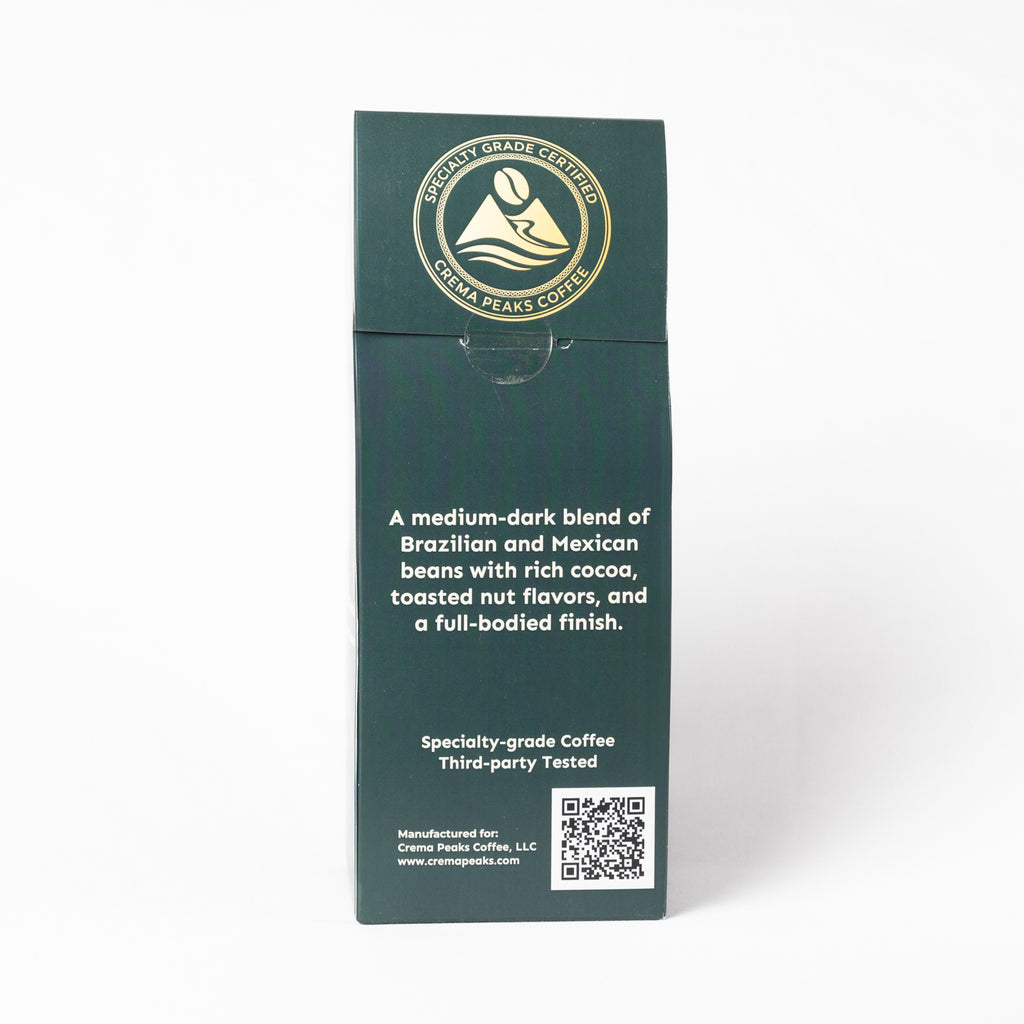 A tall, dark green coffee bag package from Cradle Peak Coffee, featuring white text and a gold circular logo at the top, set against a plain white background.