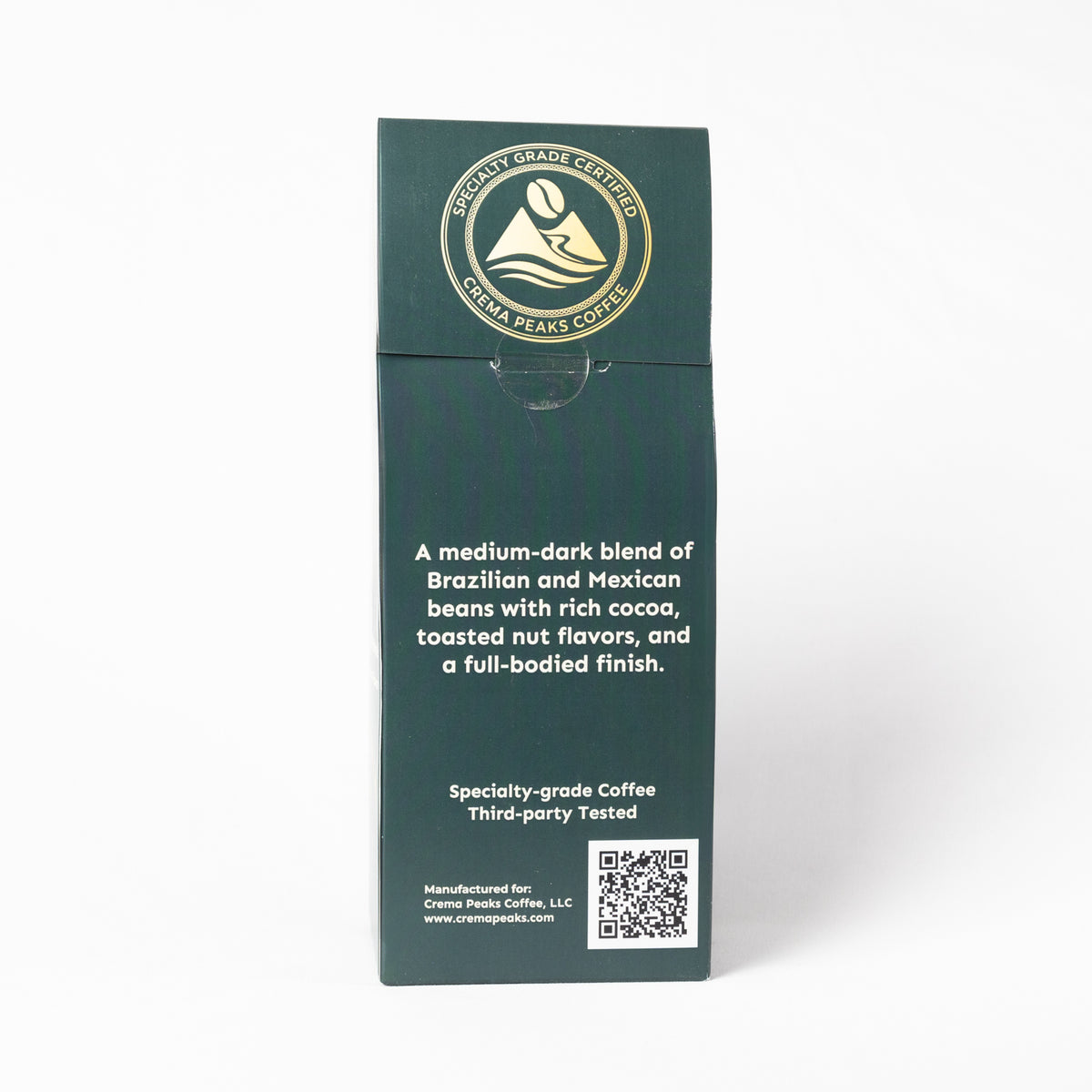A tall, dark green coffee bag package from Cradle Peak Coffee, featuring white text and a gold circular logo at the top, set against a plain white background.