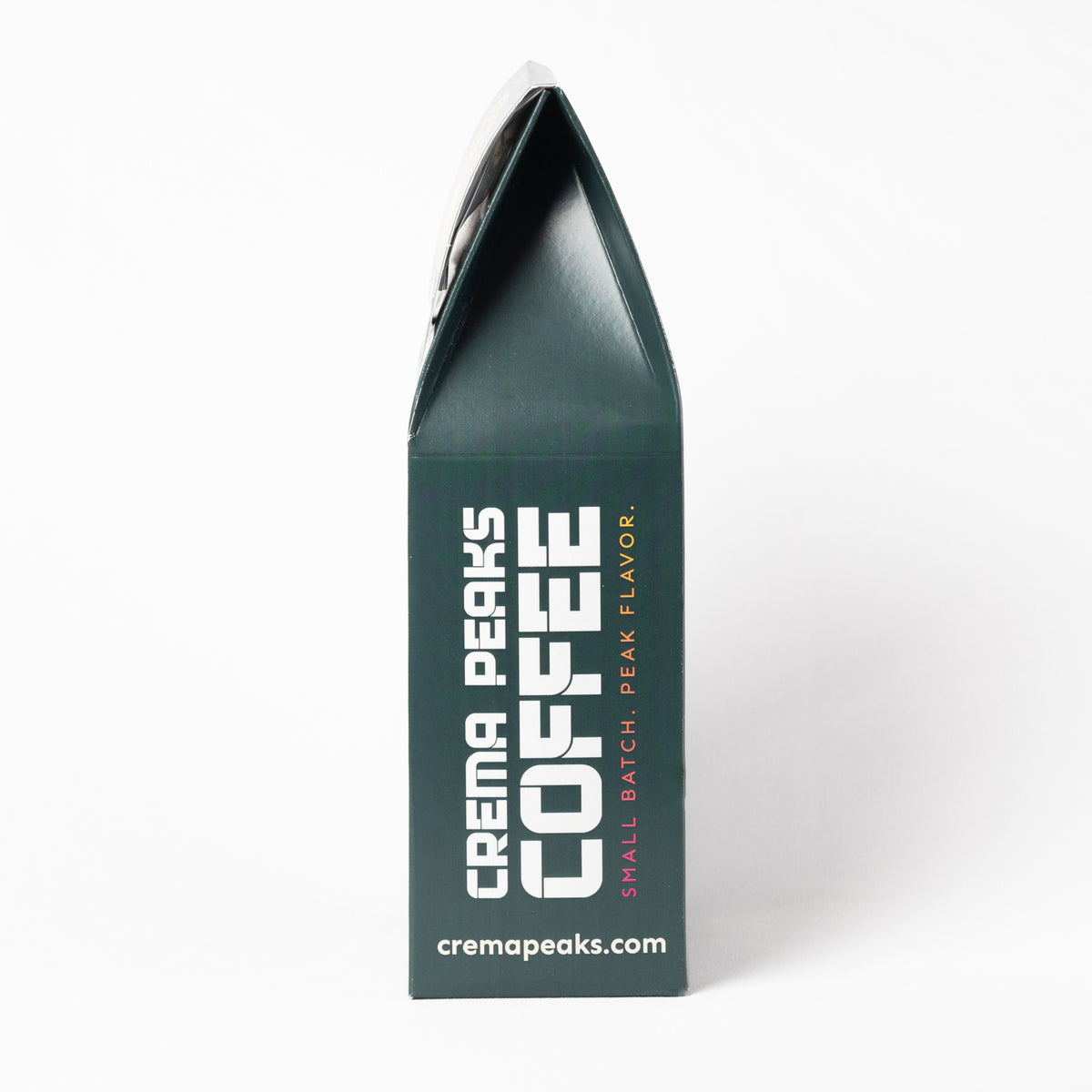 A dark green coffee bag package standing upright on a white background, with large white text reading 'CREMA PEAKS COFFEE' and smaller text 'SMALL BATCH, PEAK FLAVOR' plus the website 'cremapeaks.com'.