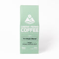 A mint green coffee box for Crema Peaks Coffee's Light Tri-Peak Blend, featuring white text and logo on a clean white background.
