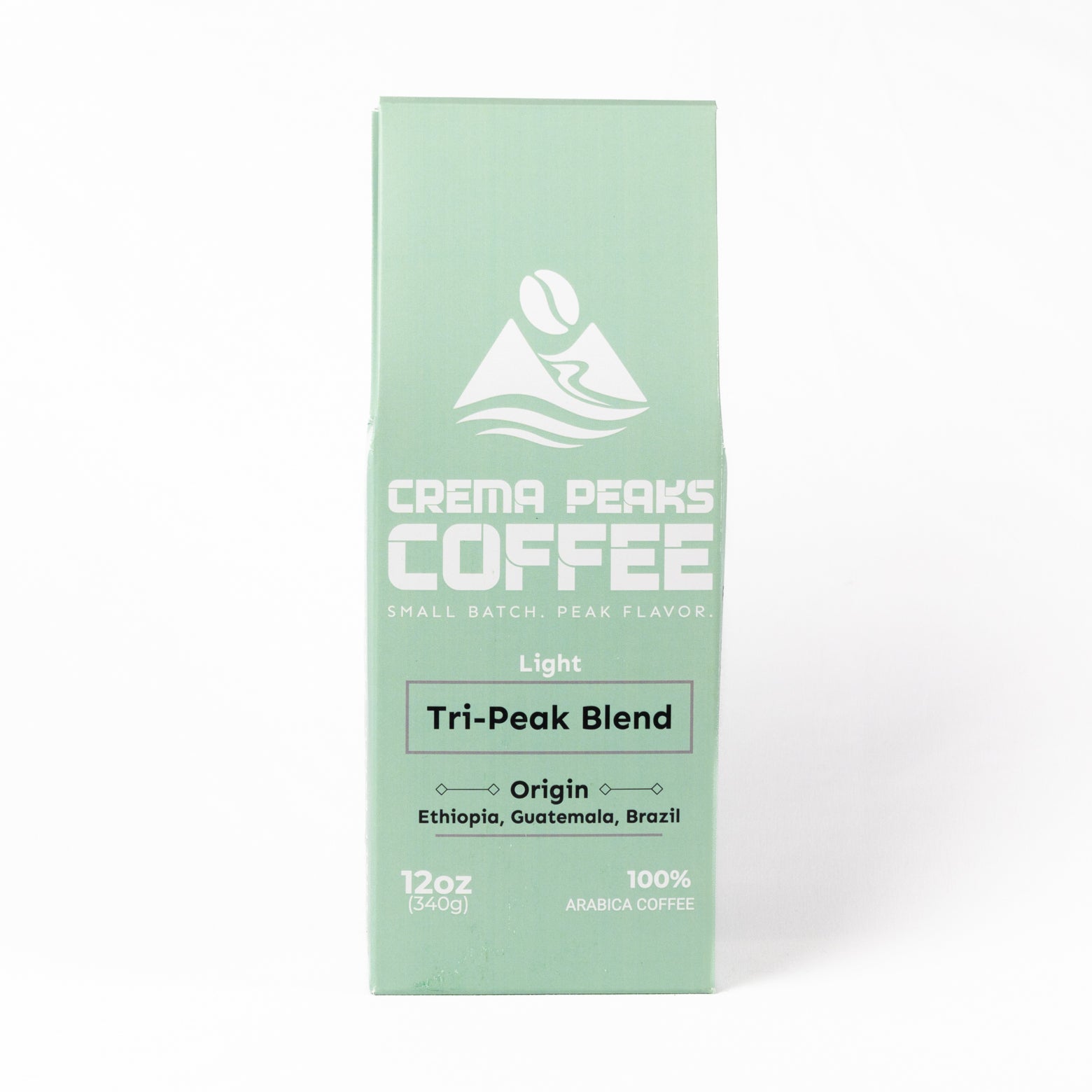 A mint green coffee box for Crema Peaks Coffee's Light Tri-Peak Blend, featuring white text and logo on a clean white background.